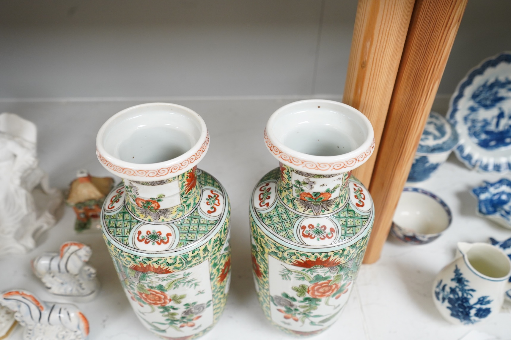 A pair of Chinese famille verte rouleau vases, enamelled with flowers, 25cm high